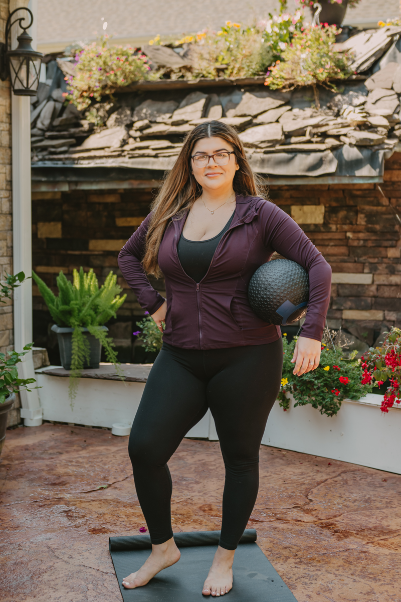 The coach is posing while holding the ball.